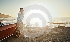 Stop seeking out the storms and enjoy more fully the sunlight. a young woman enjoying a road trip along the coast.