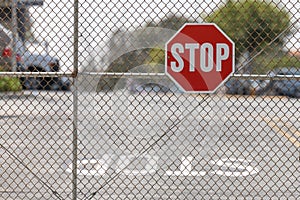 Stop sign attached to chain link fence