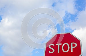 Stop sign, blue sky and wispy clouds room