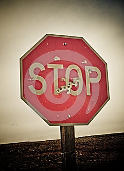 Stop sign with bullet holes