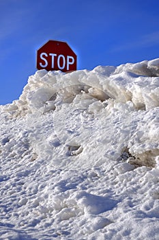 Stop Sign Buried in Snow Drift Deep Winter