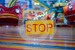 Stop sign with carnival festival blurred Carousel background