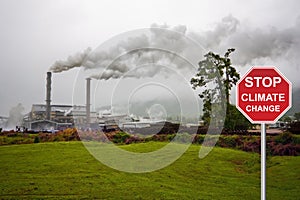 Stop sign climate change. factory emitting smoke pollution