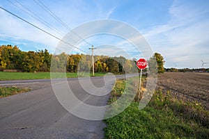 Stop sign at a deserted intersection in the countryside