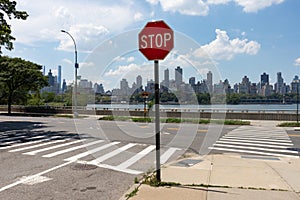 Stop Sign on the East River Riverfront of Astoria Queens New York with the Roosevelt Island and Manhattan Skyline during Summer