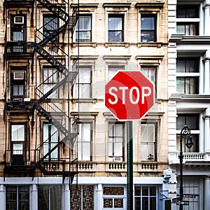 Stop Sign in front of Old Buildings in New York City