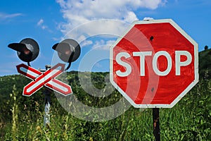 Stop sign in front of a railway crossing