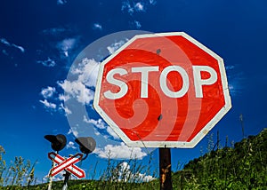 Stop sign in front of a railway crossing