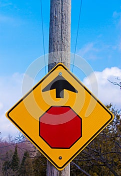 Stop Sign Mounted on Telephone Pole Giving Direction