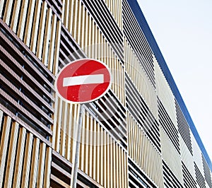 Stop sign near new parking building, empty street nobody concept