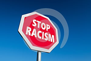 Stop sign with STOP RACISM text photo