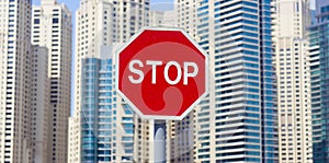 Stop sign on the road in city with buildings