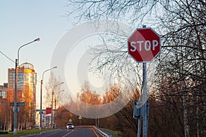 Stop sign on the side of the road at the entrance to the city