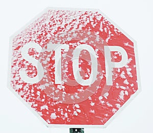 Stop sign with snow