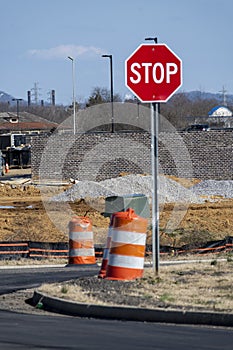 Stop Sign and Traffic Barrels At New Road Construction