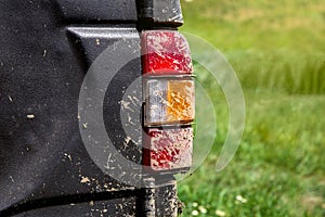 Stop signal taillight with turn signals smeared with swamp close-up.