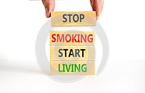 Stop smoking start living symbol. Concept words Stop smoking start living on cubes. Beautiful white background. Doctor hand.