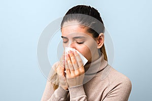 Stop spreading covid-19. young sick woman with virus sneezing and coughing in a mask or napkin. rules of coronavirus