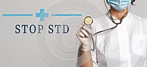 STOP STD - concept of text on gray background. Nearby is a cropped view of doctor with stethoscope