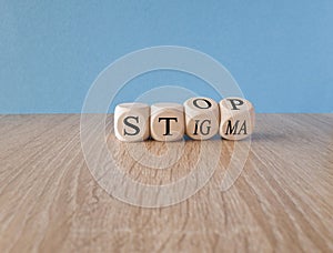Stop stigma symbol. Doctor turns cubes with words stop stigma. Beautiful blue background. photo