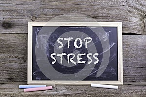 Stop Stress. Old wooden background with texture and chalk blackboard