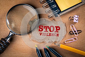 STOP VIOLENCE concept. Magnifying glass, stationery and note paper
