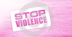 Stop violence words on card on wooden table. Social concept