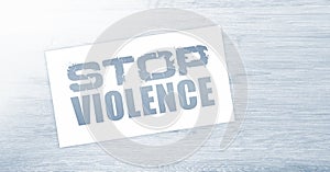 Stop violence words on card on wooden table. Social concept