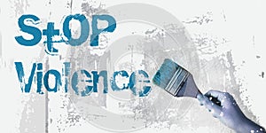 Stop Violence words on wall ,paintbrush. Domestic abuse prevention concept photo