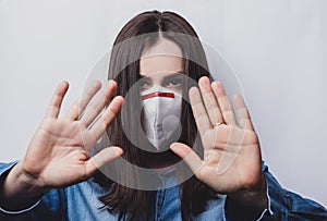 Stop the virus. Healthy woman in medical protective mask showing gesture stop