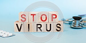 Stop virus word written on wood block. text on blue desk for your desing, Concept