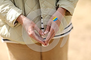 Stop War. Peace in Ukraine. woman with picture of flag of ukraine on hand. Antiwar support concept. High quality photo