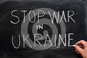 Stop war in Ukraine, written on a blackboard photo