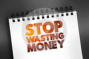 Stop Wasting Money text quote on notepad, concept background