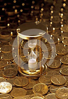 Stop watch on heaped of gold coins photo