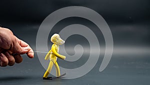 Stopmotion process of walking. Man's hand holding with an aluminum wire a figure