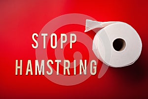 Stopp hamstring norwegian word toilet paper text wooden letter on red background coronavirus covid-19 photo