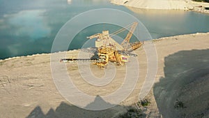 Stopped bucket wheel excavator sitting on the sandy excavation site