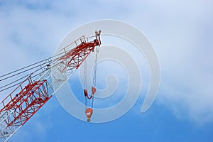 Stopped high red crane with blue sky clouds as copy space background