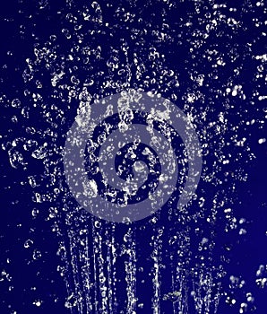 Stopped motion water drops on deep blue