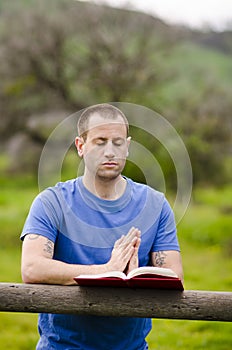 Stopping to pray while reading a book.