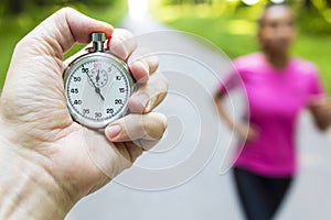 Stopwatch Timer and Young Woman Running