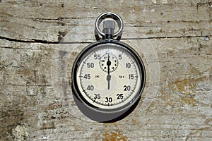 Stopwatch on wooden background, close up