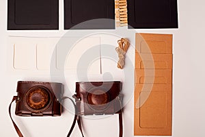 Storage and archiving of photos.Paper frames for photos, an old film camera in the case. Preserving your history. Photo