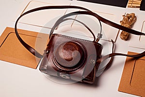 Storage and archiving of photos.Paper frames for photos, an old film camera in the case. Preserving your history. Photo