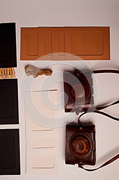 Storage and archiving of photos.Paper frames for photos, an old film camera in the case. Preserving your history. Photo