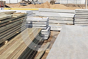 Storage of boards and building materials at the construction site. Preparation of material for building a house