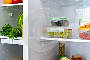 Storage containers with fresh food in a fridge