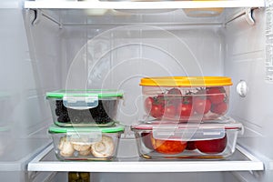 Storage containers with fresh food in a fridge