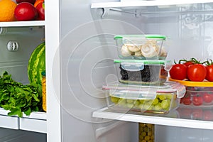 Storage containers with fresh food in a fridge
